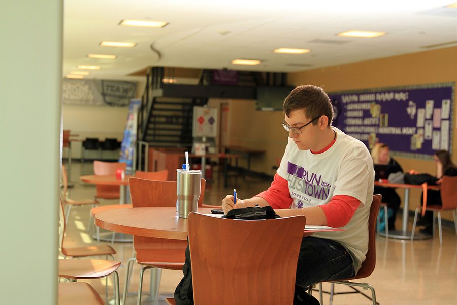 student at table with books