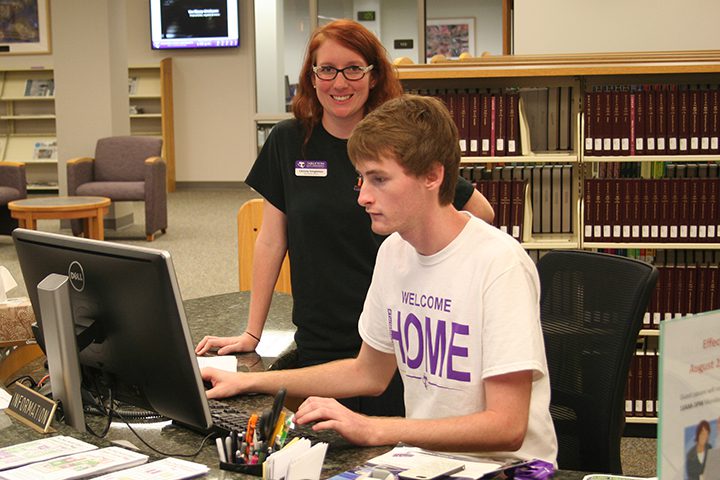 librarian and student at desk