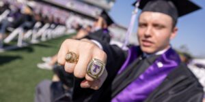 Tarleton Graduate proudly brandishing class rings during commencement