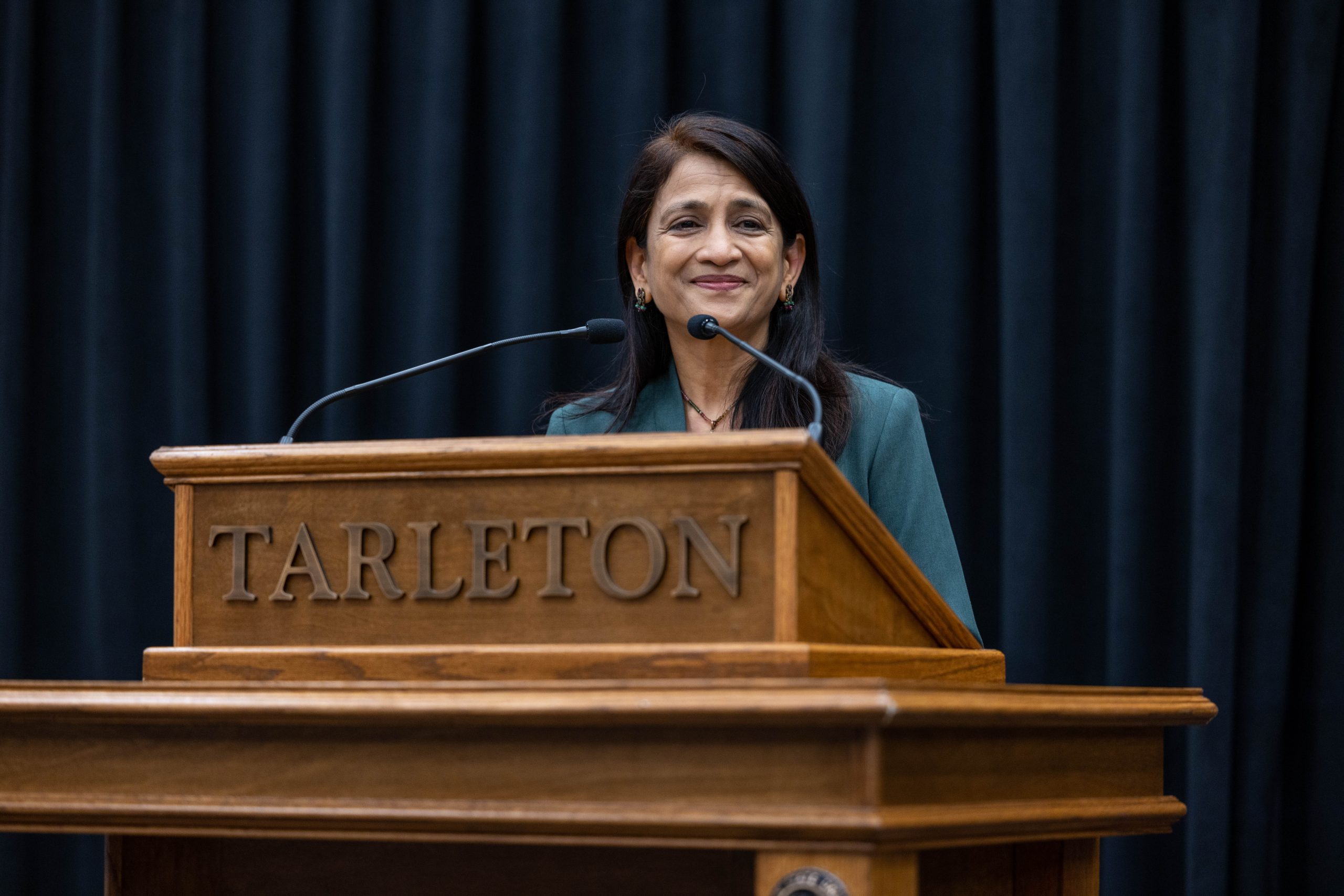 Dr. Iyer standing behind a podium