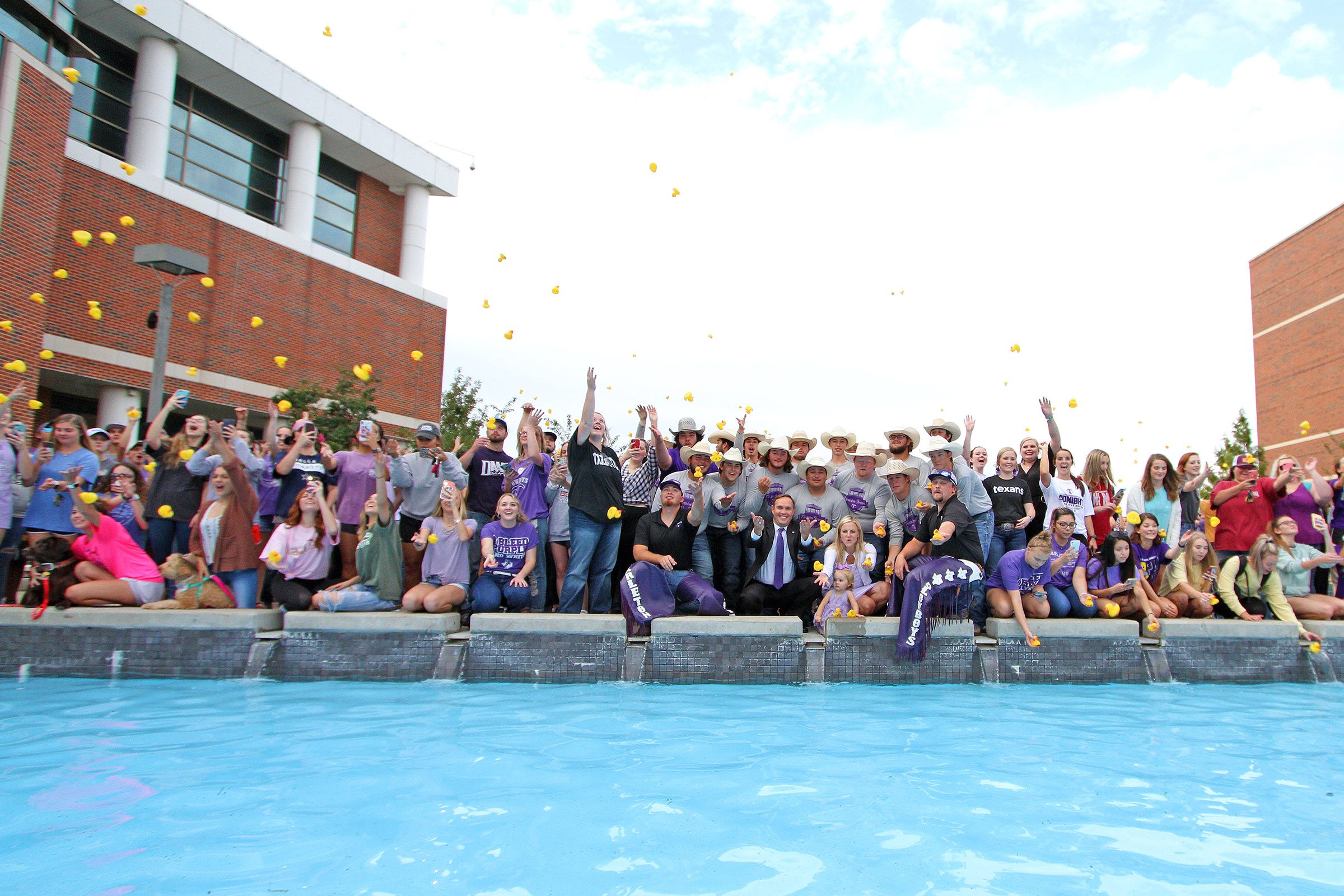A group of students sending off their rubber ducks into the nursing pool, featuring Dr. Hurley and Mrs. Hurley.