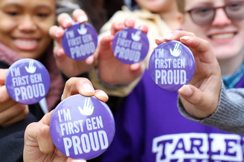 Students holding up I'm first Gen proud buttons